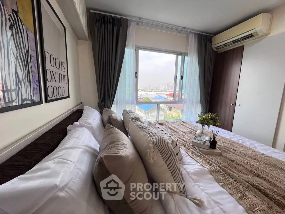 Cozy bedroom with stylish decor and city view from window