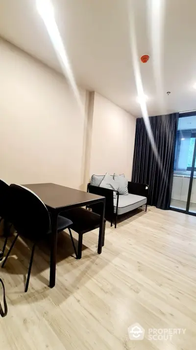 Modern living room with sleek furniture and wooden flooring in a stylish apartment.