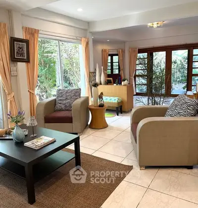 Charming living room with cozy seating and garden view, perfect for relaxation and entertaining.
