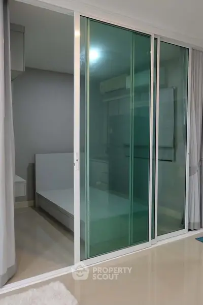Modern bedroom with sliding glass doors and minimalist design