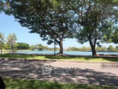 Scenic view of a serene lake surrounded by lush greenery and trees, perfect for nature lovers.