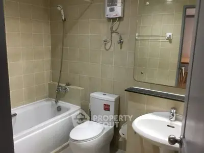 Modern bathroom with bathtub and sleek fixtures in a contemporary apartment.