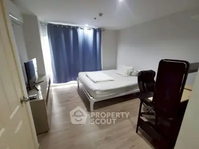 Cozy bedroom with modern furnishings and natural light in a stylish apartment.