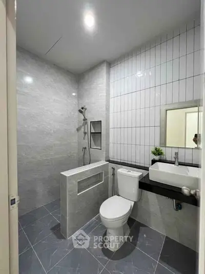 Modern bathroom with sleek gray tiles and contemporary fixtures