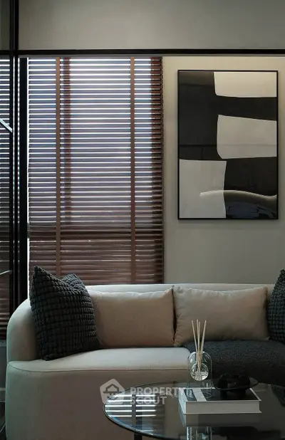 Modern living room with stylish sofa, abstract art, and wooden blinds for a cozy ambiance.