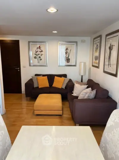Cozy living room with stylish decor and comfortable seating in modern apartment.