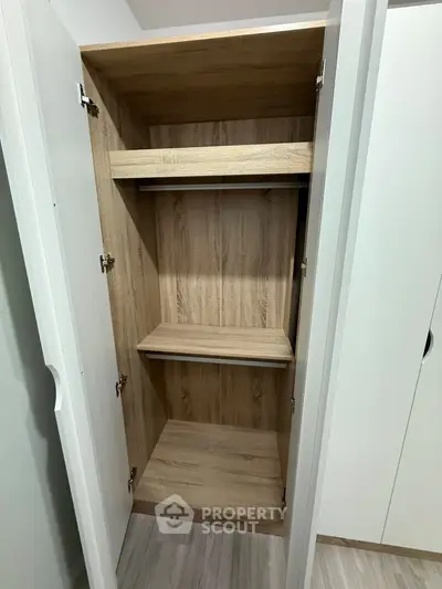 Spacious wooden wardrobe with shelves in modern interior design