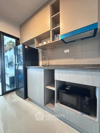 Modern kitchen with sleek cabinetry and appliances in stylish apartment