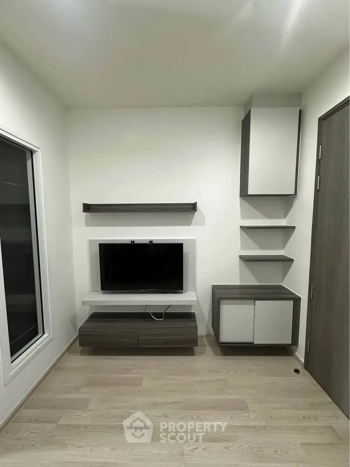 Modern living room with sleek TV unit and minimalist shelving