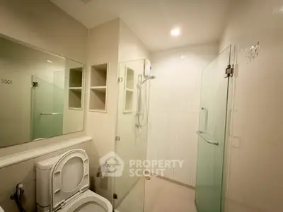 Modern bathroom with glass shower and sleek fixtures