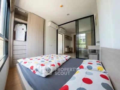 Modern bedroom with colorful bedding and built-in wardrobe in a bright apartment