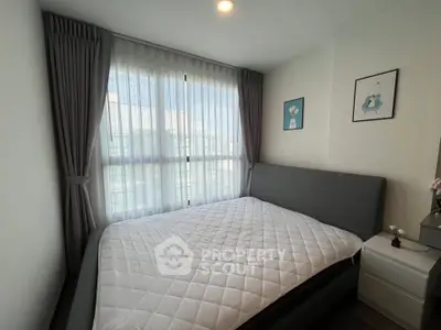 Cozy bedroom with modern decor and large window for natural light
