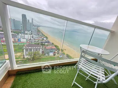 Stunning beachfront balcony with panoramic ocean and city views, perfect for relaxation and enjoying the coastal lifestyle.