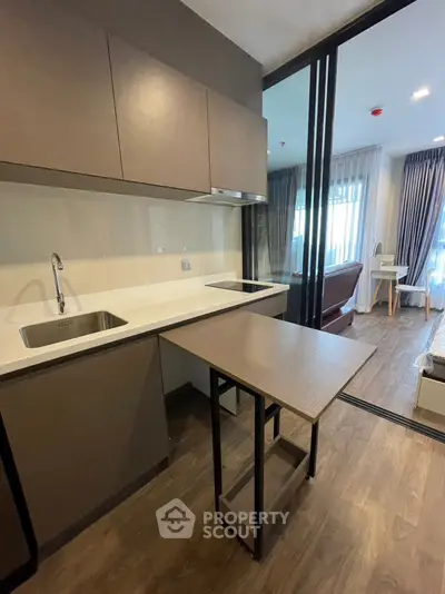 Modern kitchen with sleek cabinetry and open layout in stylish apartment