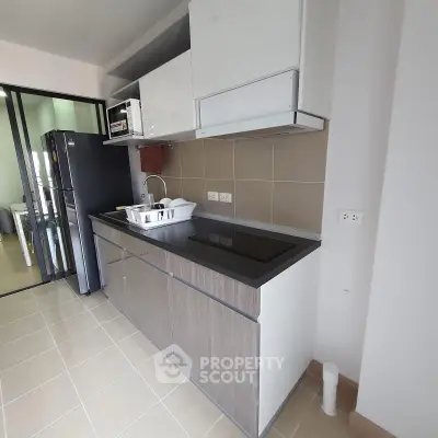 Modern kitchen with sleek cabinetry and built-in appliances in a contemporary apartment.