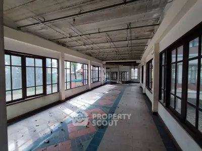 Spacious sunlit room with large windows and tiled floor, perfect for creative renovation.
