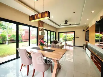 Spacious modern living room with garden view and elegant dining area.