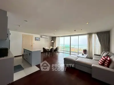 Spacious modern living room with ocean view, open layout, and elegant decor.