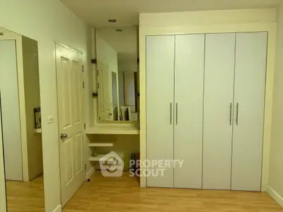 Spacious bedroom with built-in wardrobe and wooden flooring