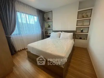 Cozy bedroom with modern decor and large window for natural light