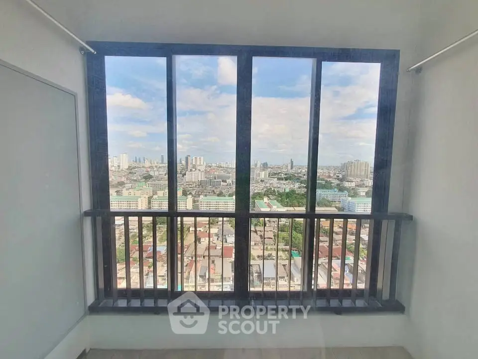 Stunning cityscape view from high-rise apartment window, offering panoramic urban vistas.