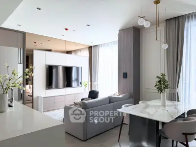 Luxurious modern living room with sleek design and elegant decor, featuring a large TV and stylish furniture.