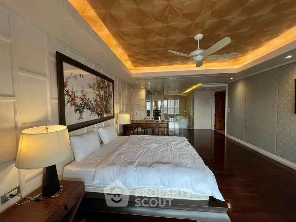 Luxurious bedroom with elegant decor and ambient lighting, featuring a large bed and stylish ceiling design.