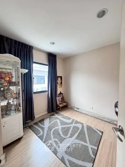 Cozy room with modern decor and ample natural light, perfect for a small study or reading nook.