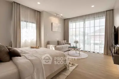 Spacious modern bedroom with elegant decor and natural light