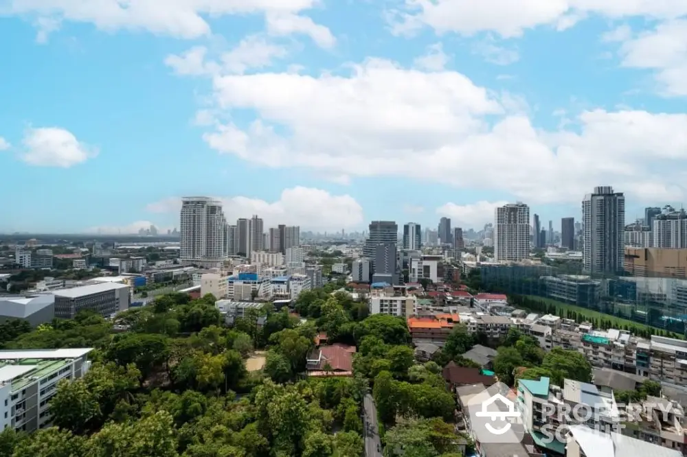 Stunning cityscape view with lush greenery and modern skyscrapers under a bright blue sky.