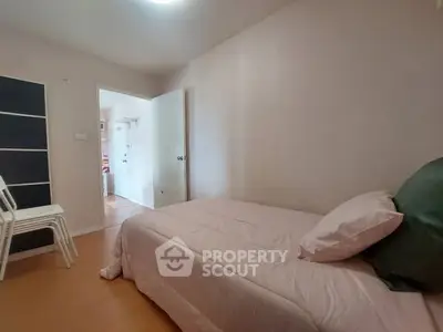 Cozy bedroom with soft pink bedding and minimalist decor