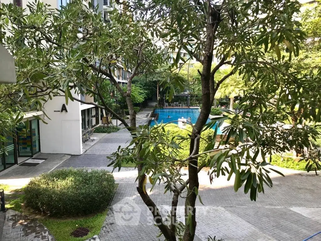 Lush garden view with pool in modern residential complex