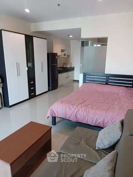 Modern studio apartment with sleek kitchen and cozy living area, perfect for urban living.