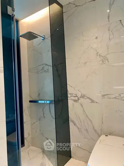 Luxurious modern bathroom with marble walls and sleek shower design