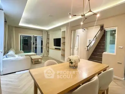 Spacious modern living room with elegant dining area and stylish lighting