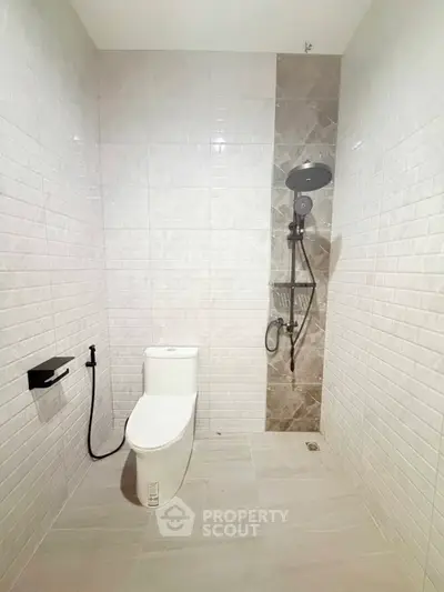 Modern minimalist bathroom with sleek shower and toilet design