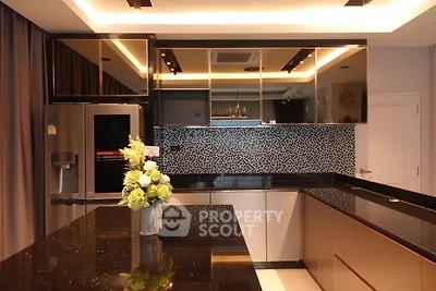 Luxurious modern kitchen with sleek black countertops and stylish backsplash