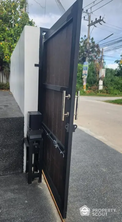 Modern black metal gate with sleek design in residential area