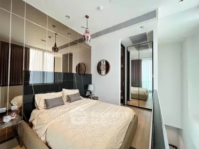 Luxurious modern bedroom with mirrored wall and elegant decor