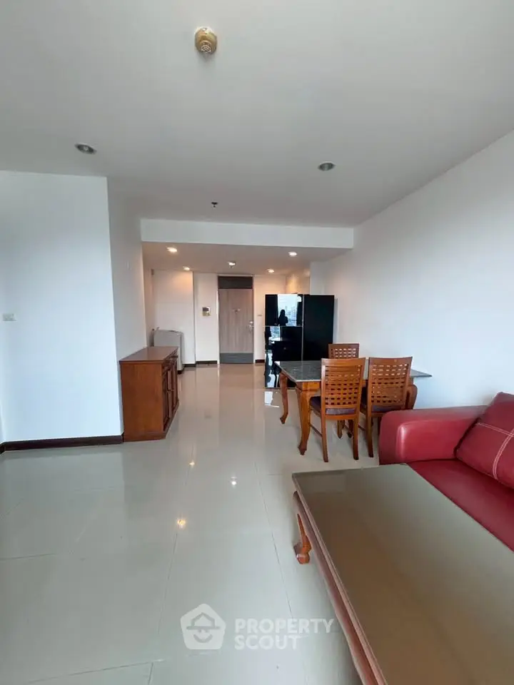Spacious living room with modern furniture and sleek design in a contemporary apartment.
