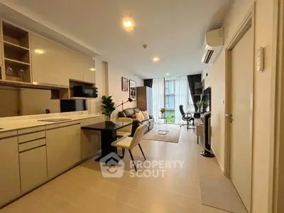Modern open-plan living room with sleek kitchen and stylish decor, perfect for urban living.