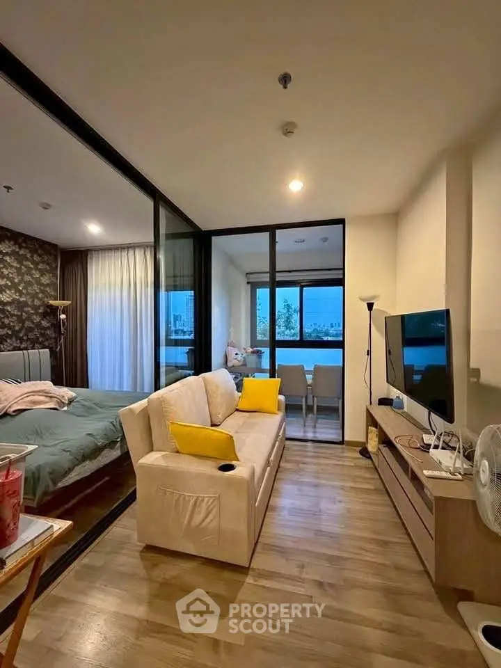 Modern apartment interior with cozy living room and bedroom, featuring stylish decor and natural light.