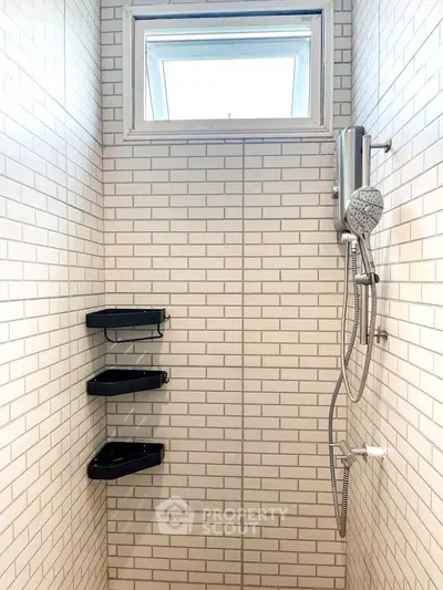 Modern bathroom shower with white subway tiles and sleek fixtures