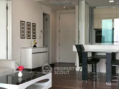 Modern living room with sleek furniture and open kitchen layout