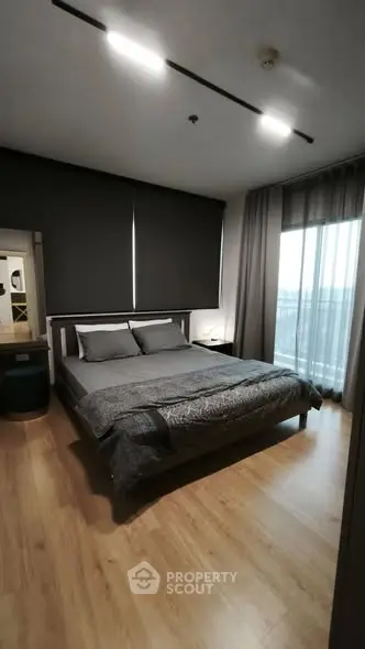 Modern bedroom with sleek design and large windows for natural light.