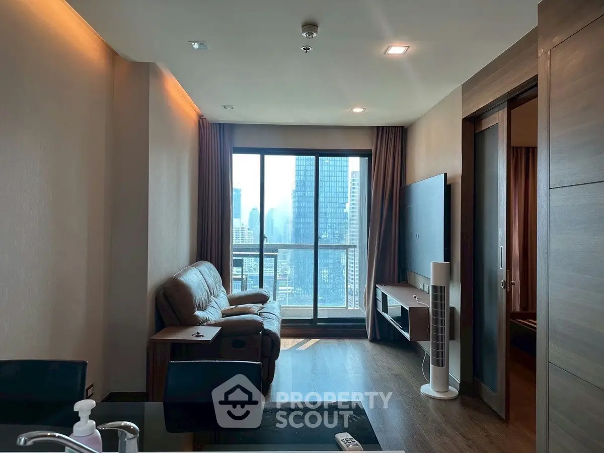 Modern living room with city view, featuring a cozy sofa and large TV, perfect for urban living.