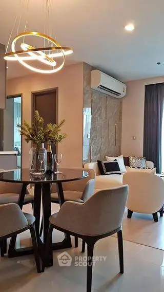 Modern living room with elegant dining area and stylish lighting in a cozy apartment.