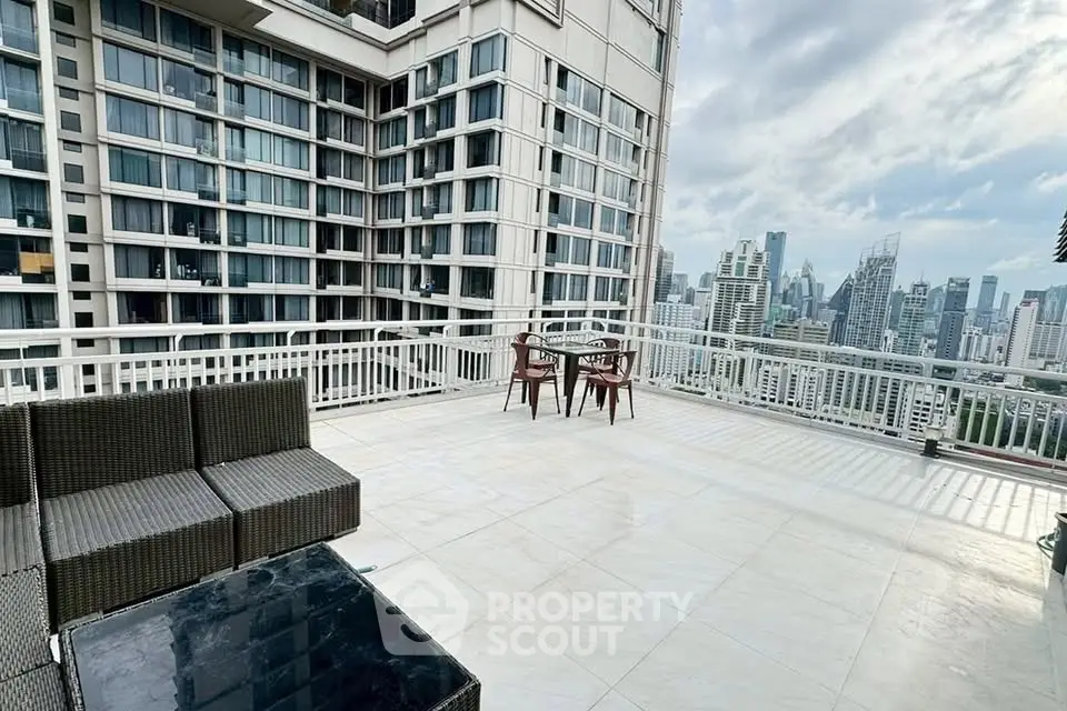 Spacious rooftop terrace with stunning city skyline views and outdoor seating area.