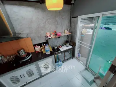 Modern kitchen with sleek design, featuring a gas stove and ample storage, perfect for culinary enthusiasts.