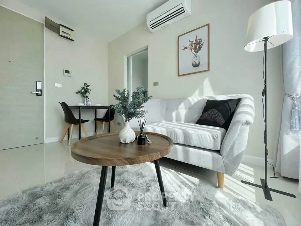 Modern living room with stylish decor and cozy ambiance, featuring a plush rug and elegant furniture.